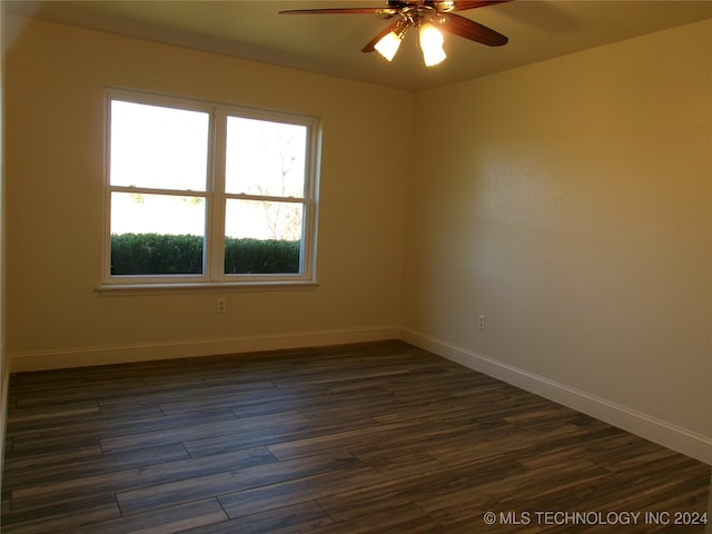 unfurnished room featuring dark hardwood / wood-style floors and ceiling fan