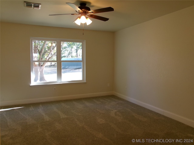 carpeted empty room featuring ceiling fan