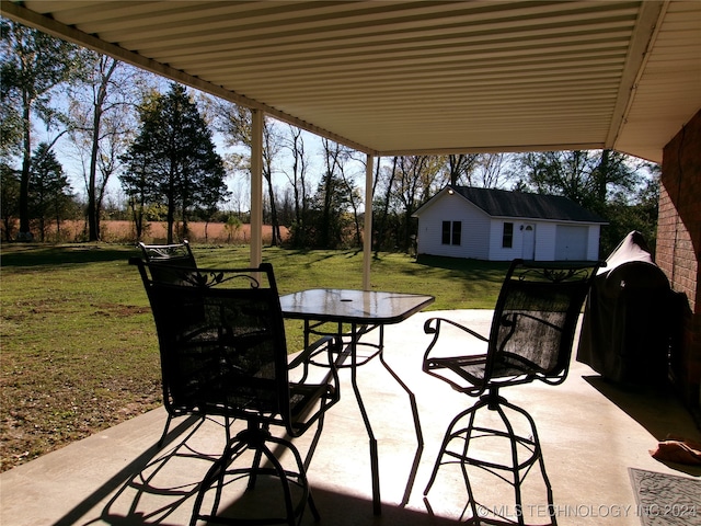 view of patio with an outbuilding