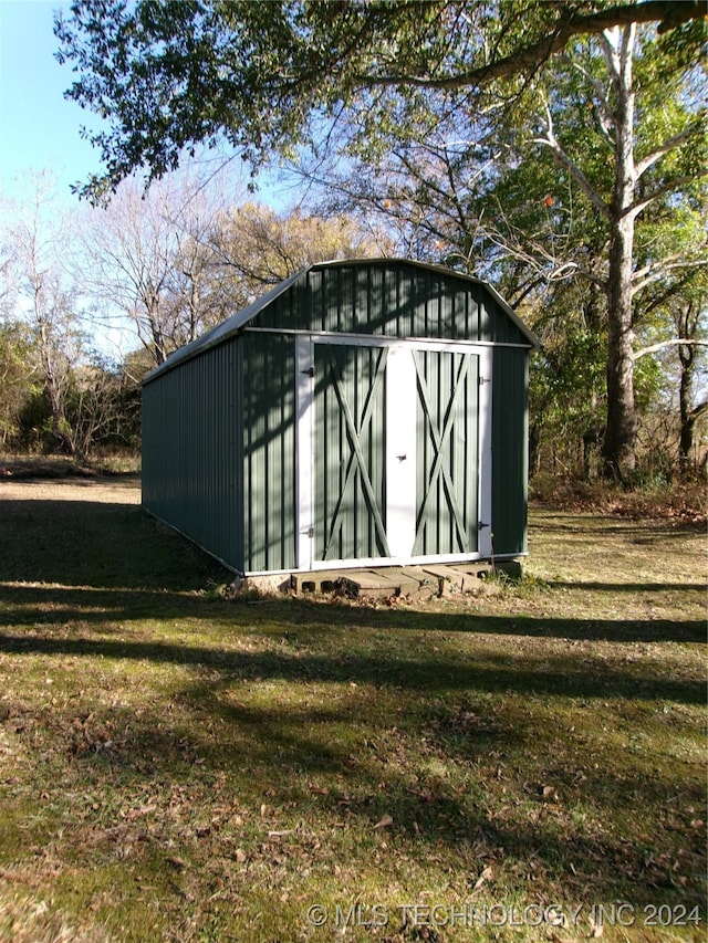 view of outbuilding featuring a lawn