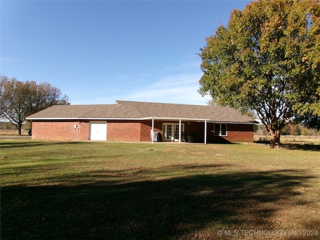 back of house with a yard