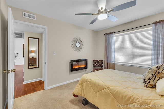 carpeted bedroom featuring ceiling fan