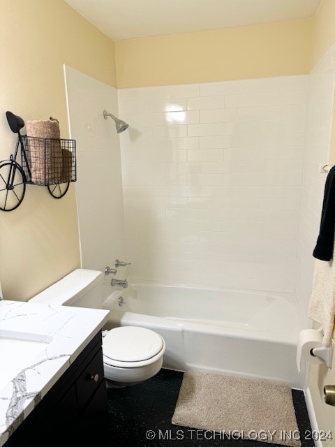 full bathroom featuring vanity, tiled shower / bath combo, and toilet