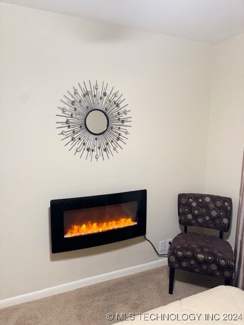 sitting room featuring light colored carpet