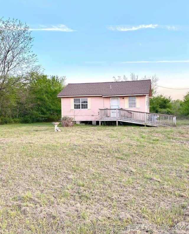 view of front of home featuring a front yard and a deck