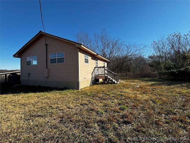 view of property exterior with a lawn