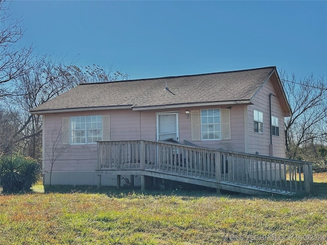 exterior space featuring a yard and a wooden deck