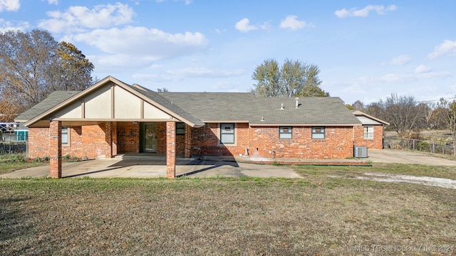 back of house featuring a yard and cooling unit