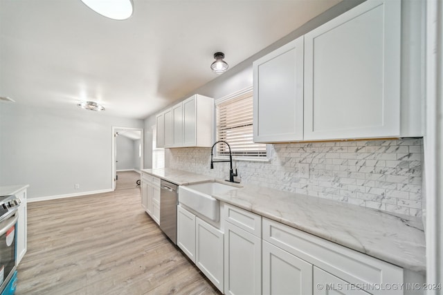 kitchen with white cabinetry, sink, light hardwood / wood-style floors, and appliances with stainless steel finishes