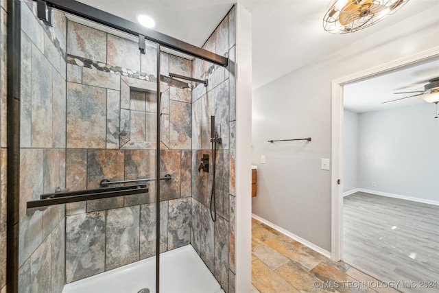 bathroom with an enclosed shower and ceiling fan