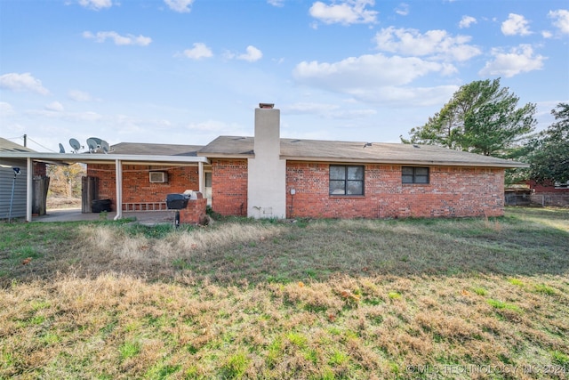 rear view of house featuring a yard