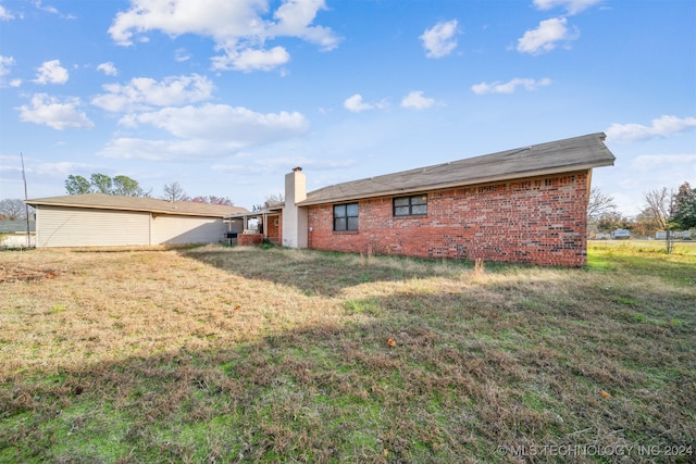 view of property exterior with a yard