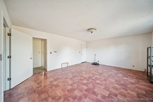 spare room featuring a textured ceiling