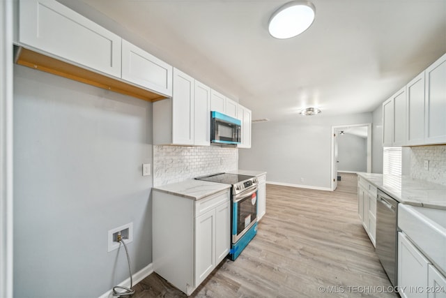 kitchen featuring white cabinetry, light hardwood / wood-style flooring, and stainless steel appliances