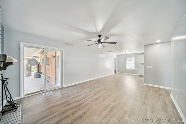 unfurnished living room featuring light hardwood / wood-style flooring and ceiling fan