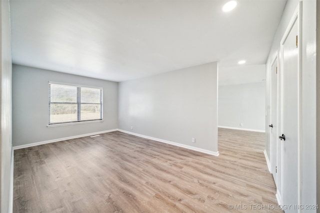 spare room with light hardwood / wood-style floors