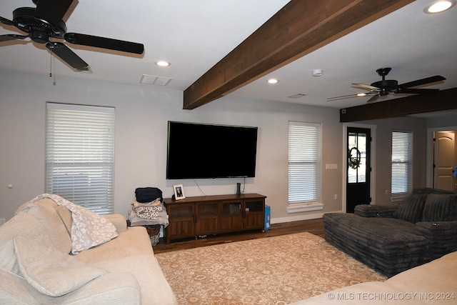 living room featuring light hardwood / wood-style flooring and beamed ceiling