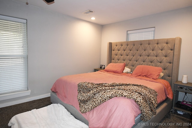 bedroom featuring dark carpet