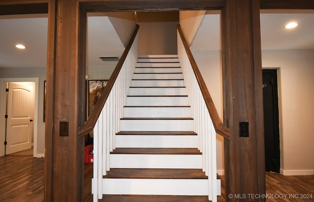 staircase with hardwood / wood-style flooring