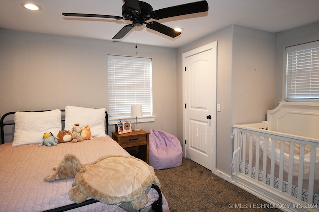 bedroom with ceiling fan and dark colored carpet