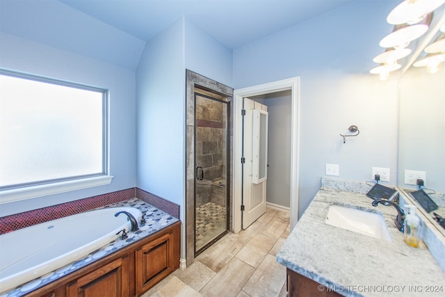 bathroom featuring a notable chandelier, vanity, and shower with separate bathtub