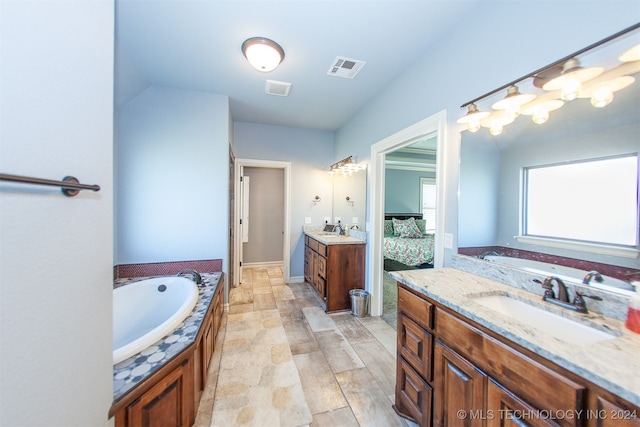 bathroom with a tub to relax in, vanity, and wood-type flooring