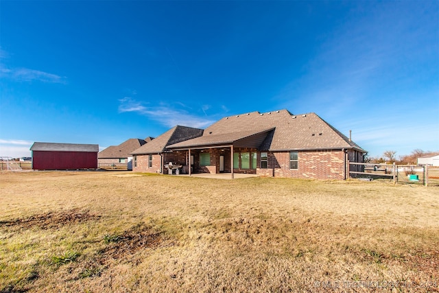 rear view of property with a lawn and a patio area