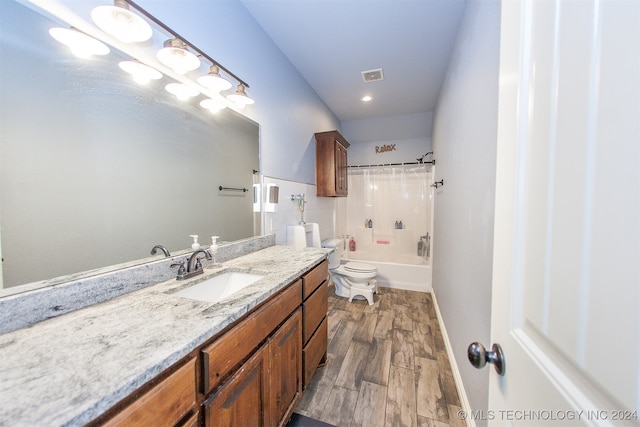 full bathroom featuring wood-type flooring, vanity, shower / tub combo, and toilet