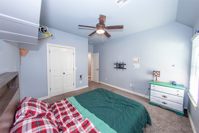 bedroom featuring carpet flooring, ceiling fan, lofted ceiling, and a closet