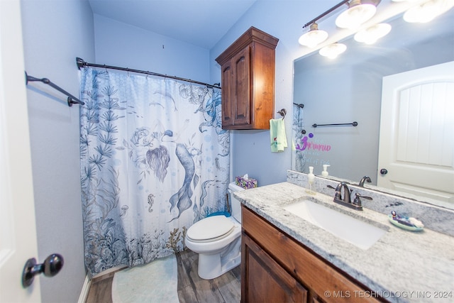 bathroom featuring hardwood / wood-style flooring, vanity, toilet, and walk in shower