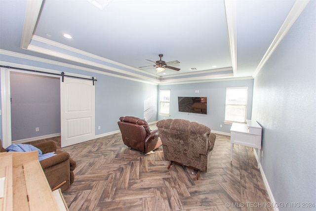 interior space featuring a tray ceiling, a barn door, and dark parquet flooring