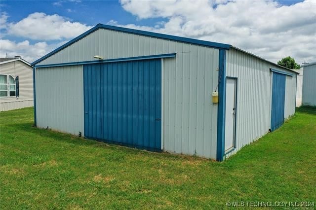 view of outbuilding featuring a yard