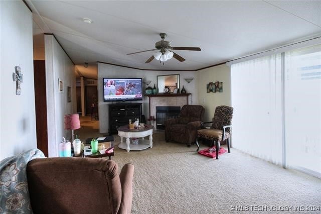 carpeted living room featuring ceiling fan