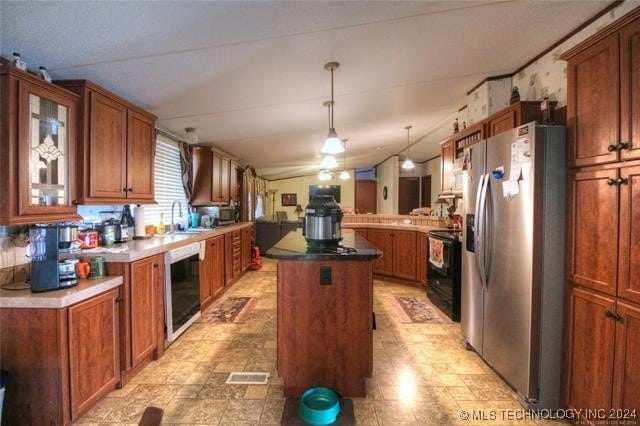 kitchen with beverage cooler, stainless steel fridge with ice dispenser, black electric range, pendant lighting, and a kitchen island