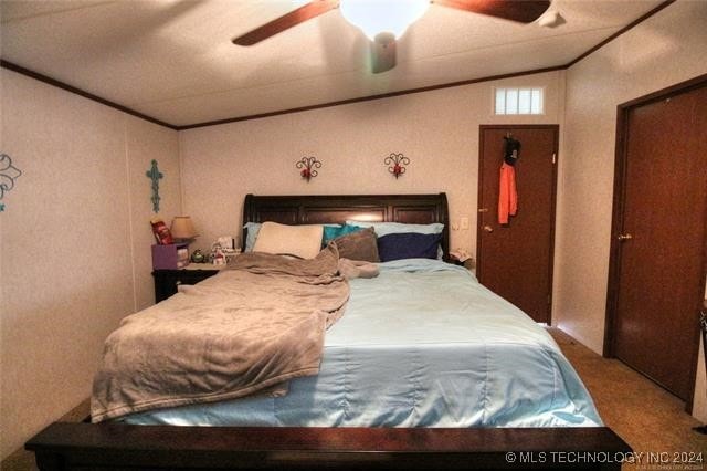 bedroom with ceiling fan, light colored carpet, and lofted ceiling