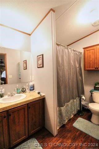 bathroom with vanity, crown molding, toilet, curtained shower, and wood-type flooring