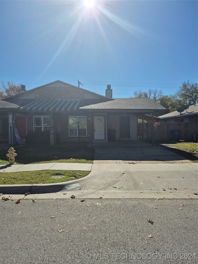 ranch-style house featuring a carport