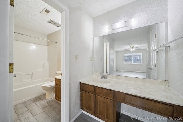 full bathroom featuring a textured ceiling, a textured wall, visible vents, and vanity