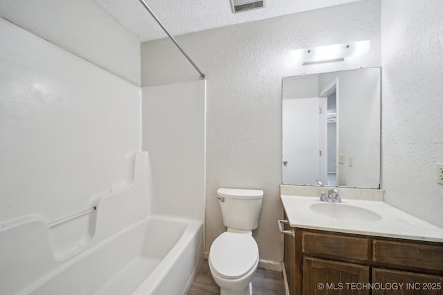 full bathroom with toilet, a textured wall, vanity, and visible vents