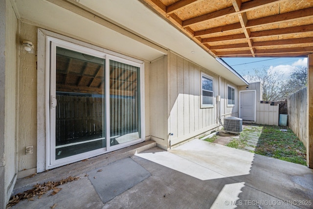 view of patio featuring cooling unit and fence