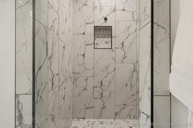 interior space featuring tiled shower