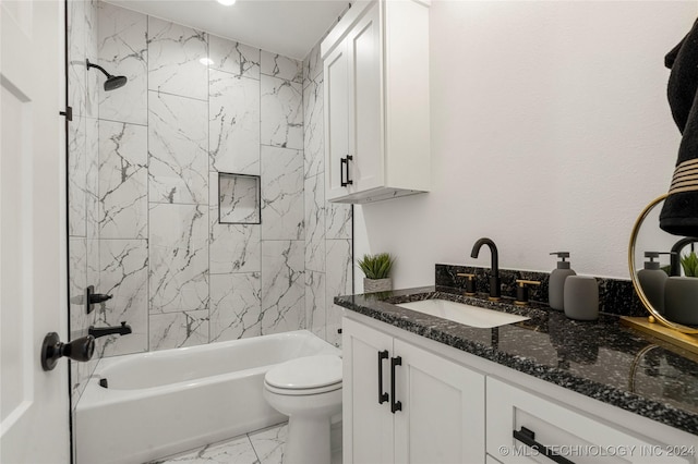 full bathroom with vanity, tiled shower / bath combo, and toilet