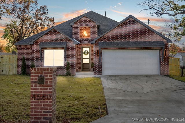 view of front property with a yard and a garage