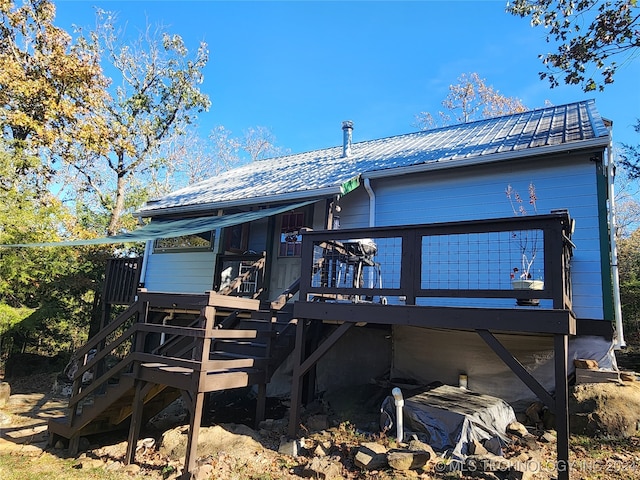 back of property featuring a deck