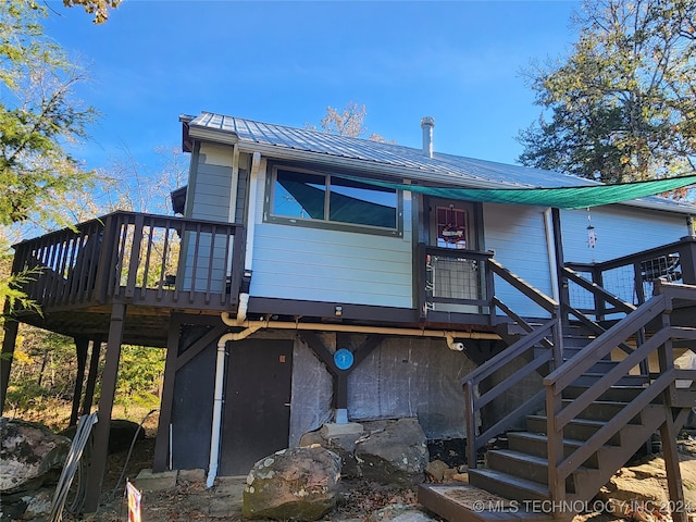 back of property with a wooden deck