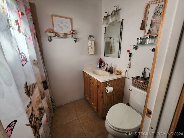 bathroom featuring tile patterned flooring, vanity, and toilet