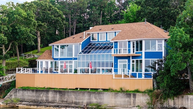 rear view of property with a balcony