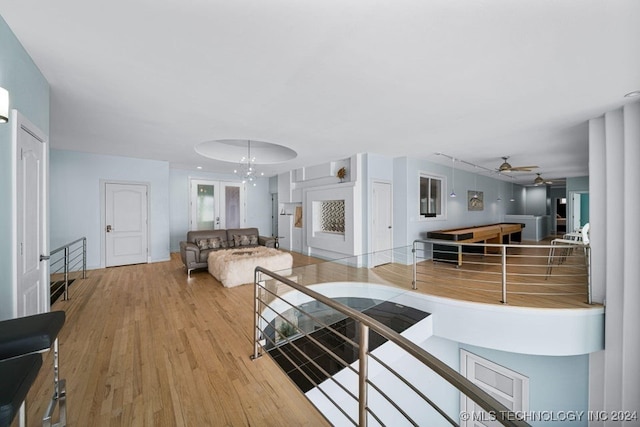 living room featuring ceiling fan and wood-type flooring