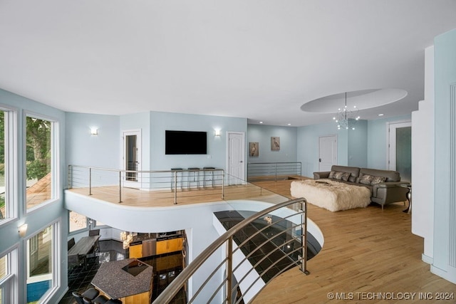 living room with a notable chandelier and light hardwood / wood-style flooring