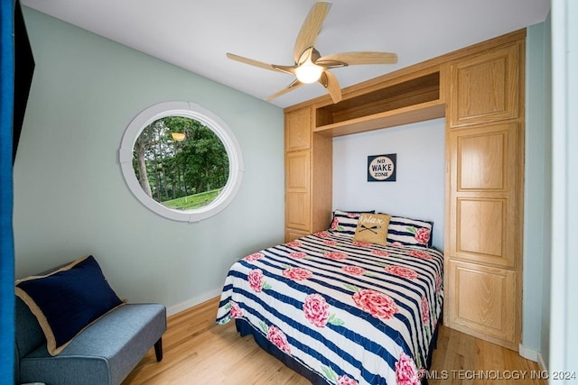 bedroom with ceiling fan and light hardwood / wood-style flooring